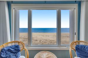 two chairs and a window with a view of the beach at Salty Sands in Ocean City