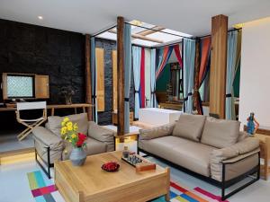 a living room with a couch and a table at Between Trees and Streams in Jiuzhaigou