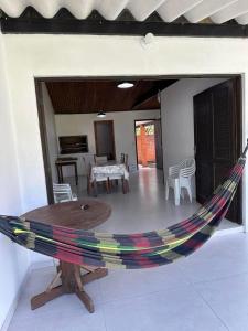 a hammock in the middle of a living room at Canto dos pássaros in Tramandaí