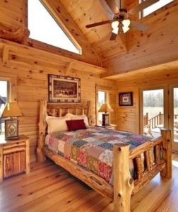 a bedroom with a bed in a log cabin at descanzar es un sueño in Urcuquí