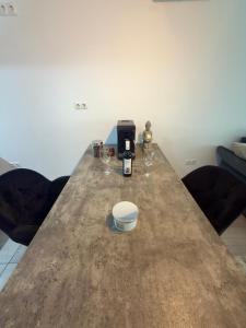 a table with a coffee maker and glasses on it at Panoramic Self Check-in Underground Parking in Iaşi