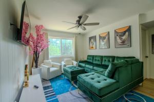 a living room with a green couch and chairs at The Homestead Luxury Cozy 2BR Apartment in Nacogdoches Near SFA University and Downtown Pet Friendly Business Ready Extended Stays Welcome with Self Check In High Speed WiFi Full Kitchen In Unit Laundry Private Parking and Quiet Comfort in Nacogdoches