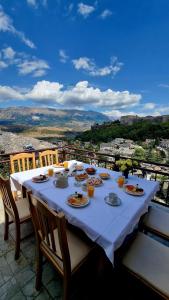 a table with plates of food on top of a balcony at Sorlesa in Gjirokastër