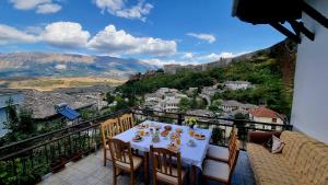 a table on a balcony with a view at Sorlesa in Gjirokastër