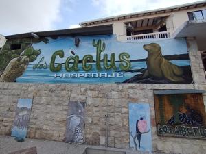 a mural on the side of a building at Hospedaje Cactus Experience in Puerto Villamil