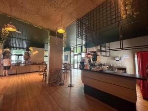 a restaurant with a counter and a bar with stools at Tropical Executive Hotel APT 606 in Manaus
