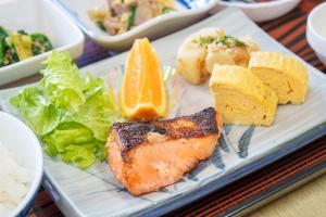 a plate of food with fish and vegetables on it at 美咲旅館 in Sakaide