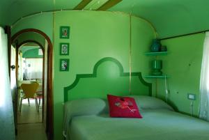 a green bedroom with a bed with a red pillow at Azienda agricola Della Mezzaluna in Stiava +37 photos