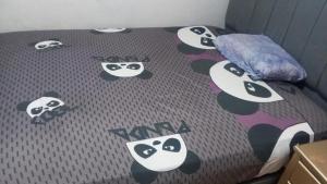 a bed with a panda comforter with pandas on it at El viajero relax in Malambo +2 photos