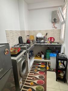 a kitchen with a stove and a dishwasher at Résidence Calme Fnideq in Fnidek