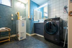 a laundry room with a washer and a washing machine at mahoratto in Aomori