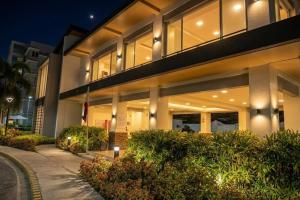 a large building with lights in front of it at Cozy 2BR Retreat at 8 Spatial Davao in Davao City