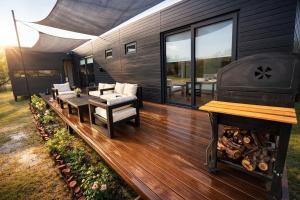 a wooden deck with a grill and furniture on a house at MODULAR NUEVA l in San Luis