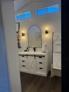 a bathroom with a sink and a mirror at Willow Pond Cabin in Ellensburg