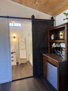 a kitchen with a sliding barn door in a room at Willow Pond Cabin in Ellensburg