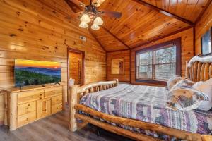 a bedroom with a bed and a flat screen tv at Cherokee Pool Lodge in Cosby +44 photos