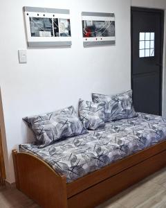 a bed with two pillows on it in a room at Departamentos Muy Eugenia in San Rafael