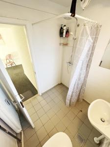 a bathroom with a shower and a toilet at Central Large Double Room with free parking in Aalborg