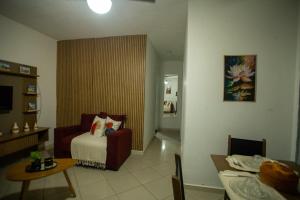 a hotel room with a bed and a table and a dining room at Apartamento Morada dos Sonhos in Lauro de Freitas