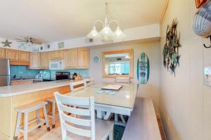 a kitchen with a table and chairs in a room at Surfs Up 301 in Ocean City