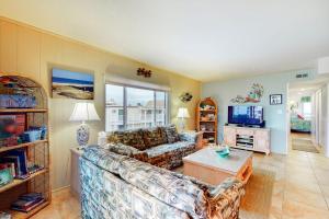 a living room with a couch and a table at Surfs Up 301 in Ocean City