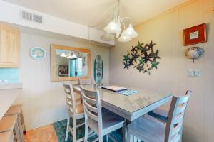 a kitchen with a dining room table and chairs at Surfs Up 301 in Ocean City