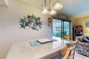 a dining room with a dining table and a dining room at Surfs Up 301 in Ocean City