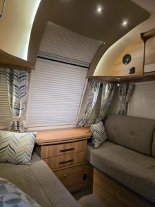 a small room with a window in an rv at Kościelnik Camp in Kościelnik