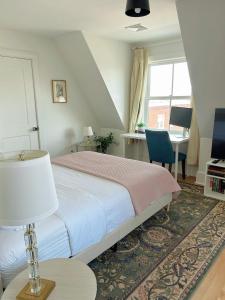 a bedroom with a bed and a table and a desk at 2BR Unit near Brown & RISD with Free Parking, Full Kitchen in Providence