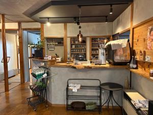 a kitchen with a counter and a table in it at Ringoya in Hakuba