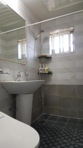 a bathroom with a sink and a mirror at 옥상달빛 게스트하우스 in Seoul