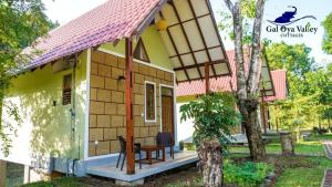 a small house with a red roof at Gal Oya Valley Cottages in Ampara
