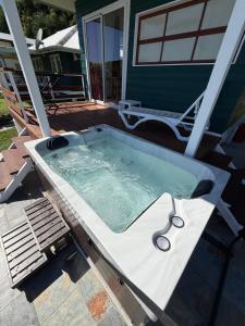 a jacuzzi tub on the back of a house at Tuava - Mirimiri Lodge in Ataiti