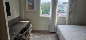 a bedroom with a bed and two windows at Alugo Suite 303 No Mont Blanc in Nova Iguaçu +7 photos
