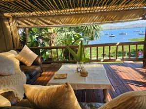 a living room with a table and a view of the water at Woodpecker cottage in Hartbeespoort