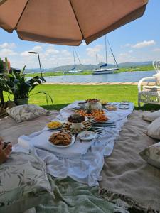 a table with plates of food on top of it at Woodpecker cottage in Hartbeespoort