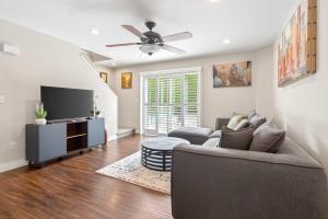 a living room with a couch and a flat screen tv at Surrey Two Bedroom Suite with Pool Access in Surrey