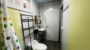 a small bathroom with a toilet and a sink at Apartamentos Equipados DMR #3 in Uvita +93 photos