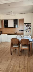a kitchen with a table and two chairs at "Private Room in New Luxury " Apartment in Ulaanbaatar +7 photos