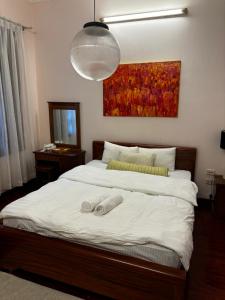 a bedroom with a large bed with white sheets at April twelve in Hanoi