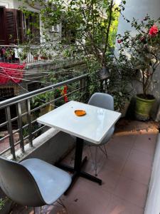 a white table and two chairs on a balcony at April twelve in Hanoi