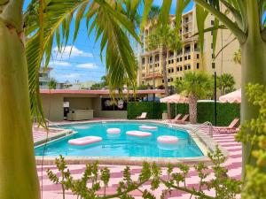 a swimming pool with lounge chairs and a building at Abode Beach House in Clearwater Beach +22 photos