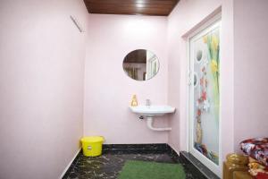 a bathroom with a sink and a mirror at Peak Homestay in Kalasa
