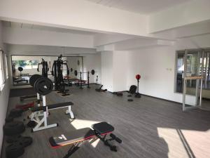 a gym with several equipment in a room at Stylish Studio Condo on the Beach in Ban Pak Khlong Phe