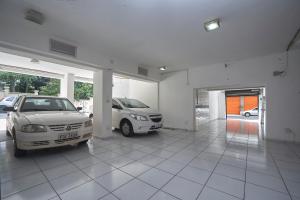 a garage with two cars parked in it at Hotel São João in Piracicaba