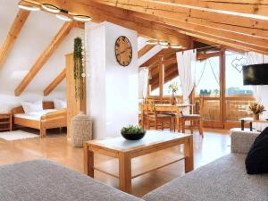 a living room with a clock on the wall at Ferienwohnungen Stecher in Bad Endorf