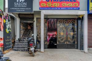 a motorcycle parked in front of a store at Hotel O Utrishree in Khandagiri