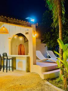 a group of chairs sitting on a patio at night at Miu Homestay Hue in Thôn Lại Thê