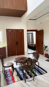 a room with a table and chairs on a rug at Samarpan in Gorakhpur