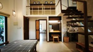 a room with a bed and a spiral staircase at Cozy & Spacious 2BR Private House in Siem Reap